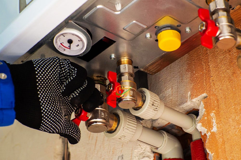 Modern renovated bathroom with new plumbing fixtures and tiled walls in a Ghanaian home by Foli-Tech Plumbing & Heating