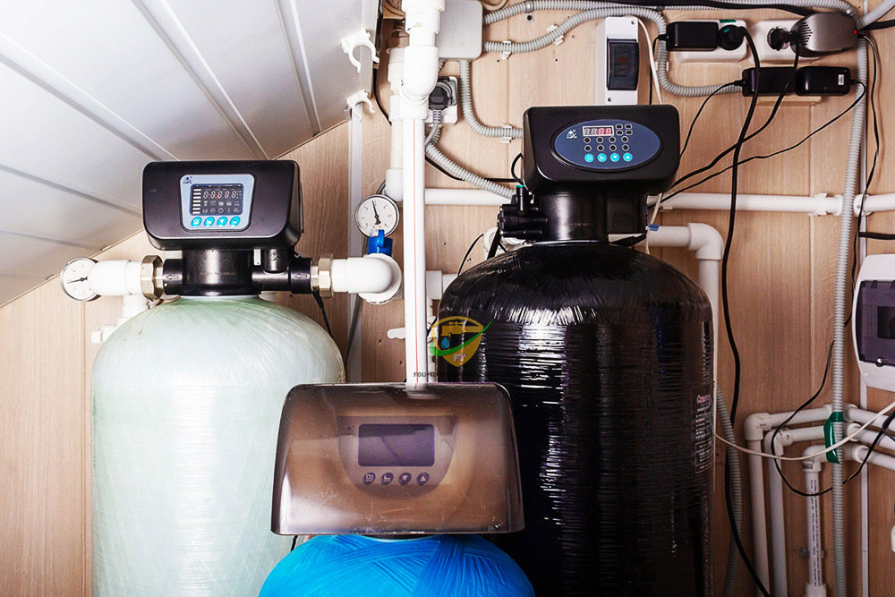 Technician testing tap water with a family drinking purified water in the background – clean water solutions by Foli-Tech in Ghana.