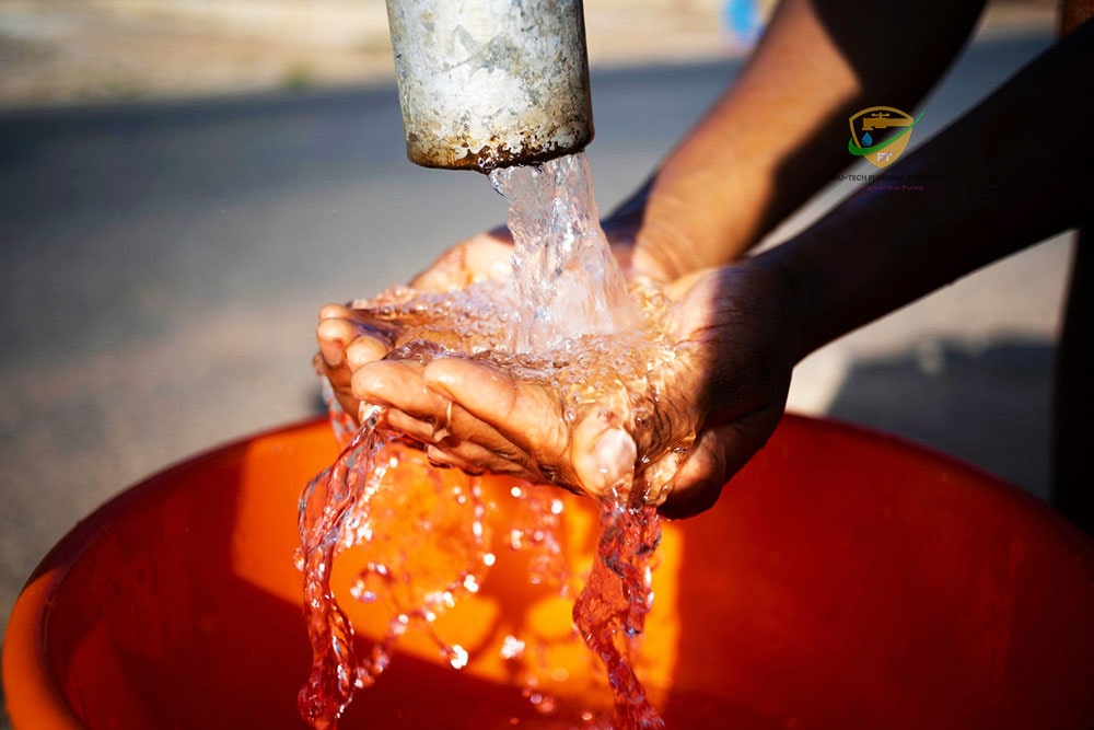 Technician operating a borehole drilling rig on a residential site in Ghana – Foli-Tech borehole drilling Ghana services with pump installation.